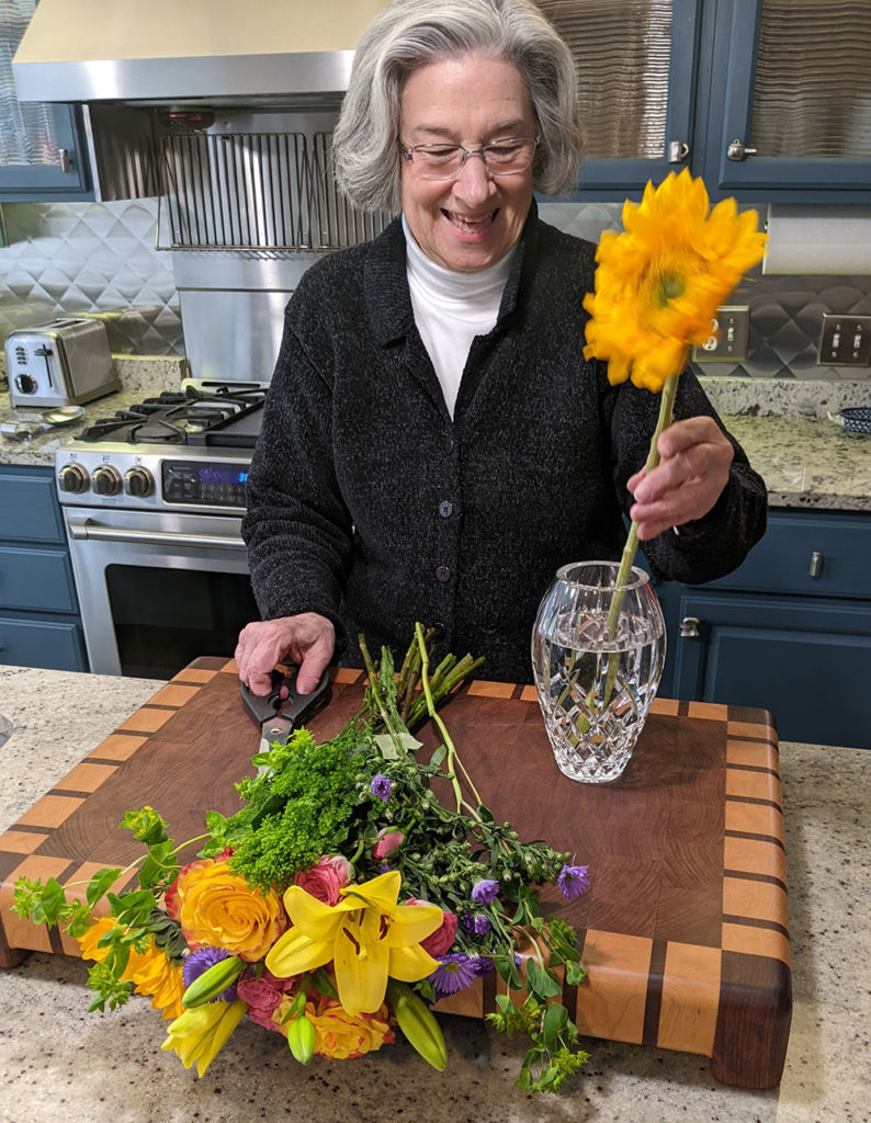 Senior arranging flowers